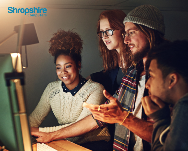 Four people looking at a computer screen