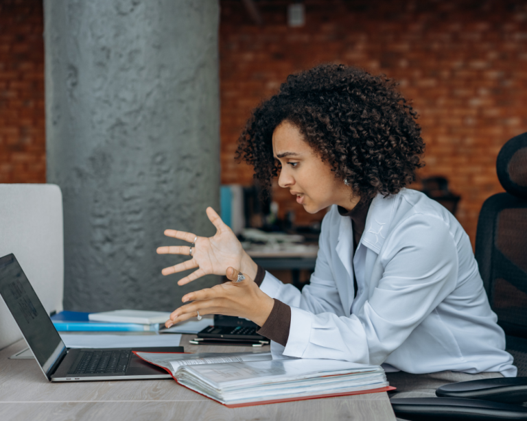 Woman looking at her laptop, feeling frustrated