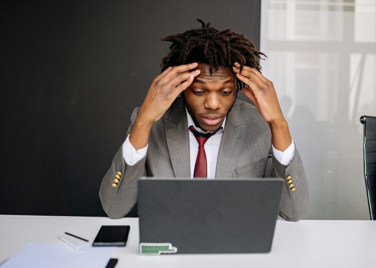 Man looking concerned at laptop