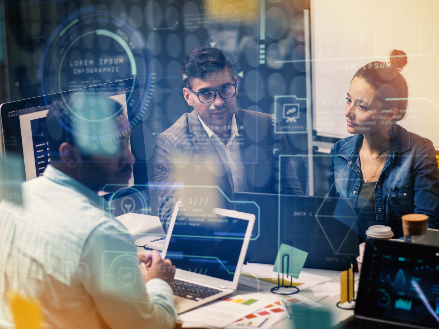 Team of IT specialists discussing digital strategies and system performance dashboards for small business clients.