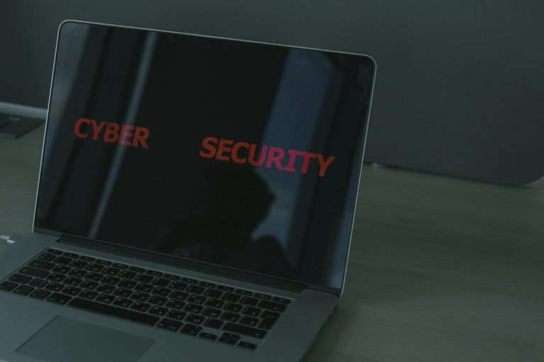A laptop with text on screen that says cyber security.