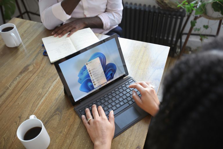 A smartphone screen displaying the Microsoft 365 app launcher interface with icons for Outlook, OneDrive, Word, Excel, PowerPoint, and SharePoint.